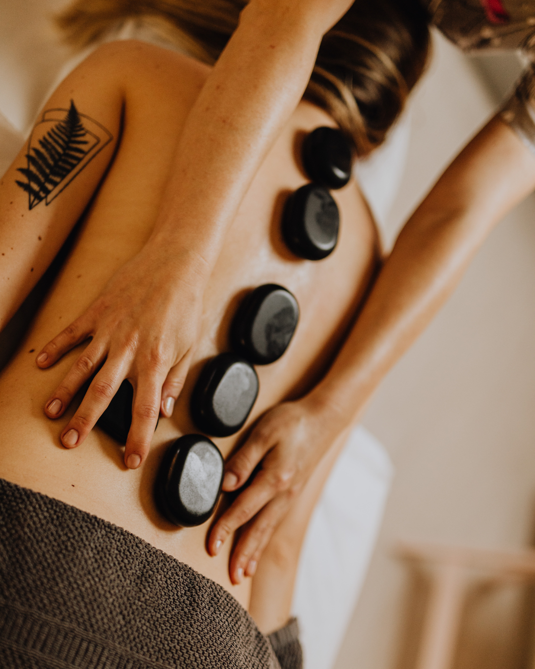 A Hot Stone Massage is a therapeutic treatment that involves the use of smooth, heated stones placed on specific parts of the body, typically along the spine, palms, and between the toes. The heat from the stones helps to relax muscles and improve circulation, providing a deeply soothing experience. This type of massage is particularly beneficial for those with chronic pain, muscle tightness, or stress-related tension. However, it’s important for the therapist to ensure that the temperature of the stones is comfortable for the client to avoid overheating.