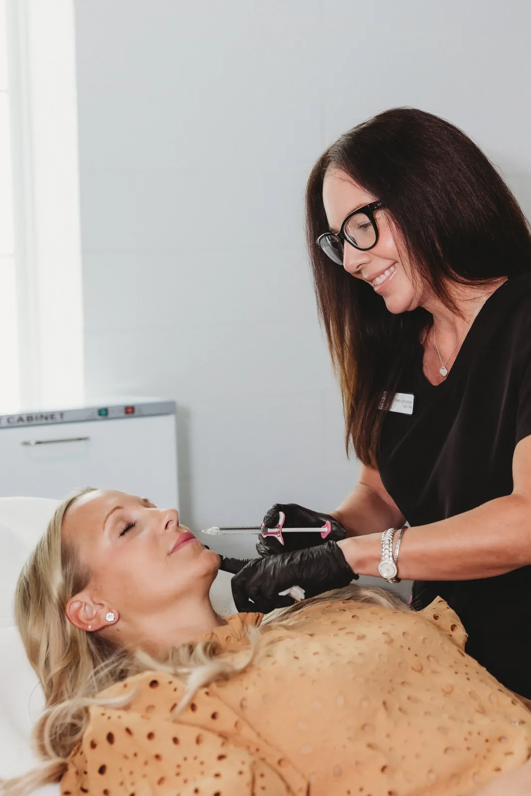 Ann Stratton, RN, injecting dermal filler near the mouth at New You Health in Peoria, IL